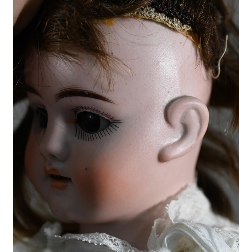 1196 - An early 20th century German Ernst Heubach china-headed girl doll with brown wig, sleeping brown eye... 