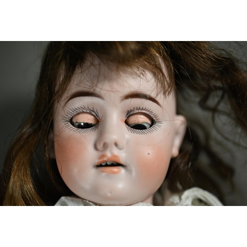 1196 - An early 20th century German Ernst Heubach china-headed girl doll with brown wig, sleeping brown eye... 