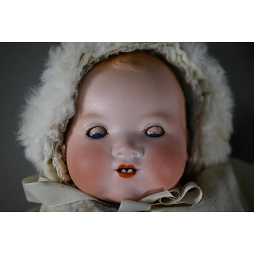 1197 - An Armand Marseille AM351/3 1/2 k bisque-headed baby doll with fixed blue eyes and open mouth with t... 