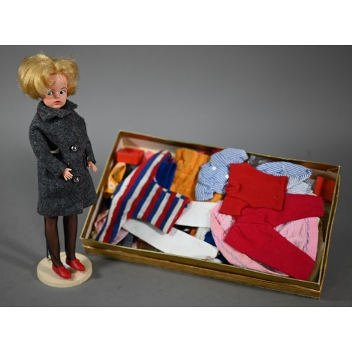 1198 - A Sindy doll with blonde bob hairstyle, to/w her stand and a quantity of natty clothing