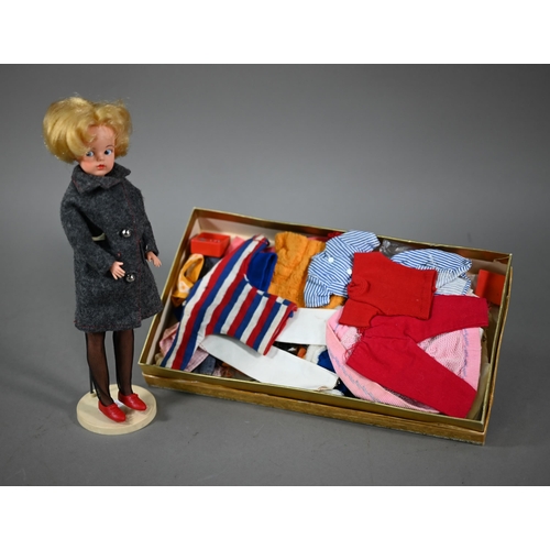 1198 - A Sindy doll with blonde bob hairstyle, to/w her stand and a quantity of natty clothing