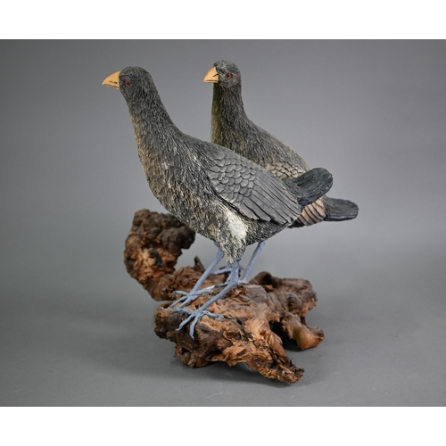 1219 - Damian Santamaria, two well executed artisan pottery birds, raised on a weathered wood root-clump ba... 