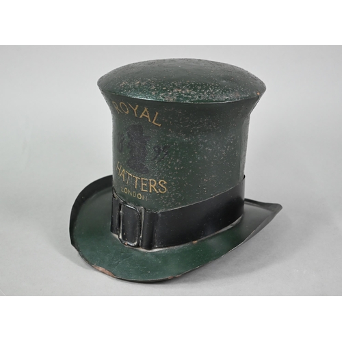 1226 - An enamelled tin trader's signed modelled as a top hat, inscribed 'Royal Hatters, London', 22 cm hig... 