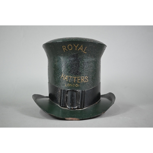 1226 - An enamelled tin trader's signed modelled as a top hat, inscribed 'Royal Hatters, London', 22 cm hig... 