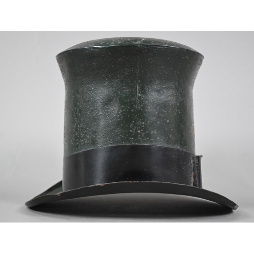 1226 - An enamelled tin trader's signed modelled as a top hat, inscribed 'Royal Hatters, London', 22 cm hig... 