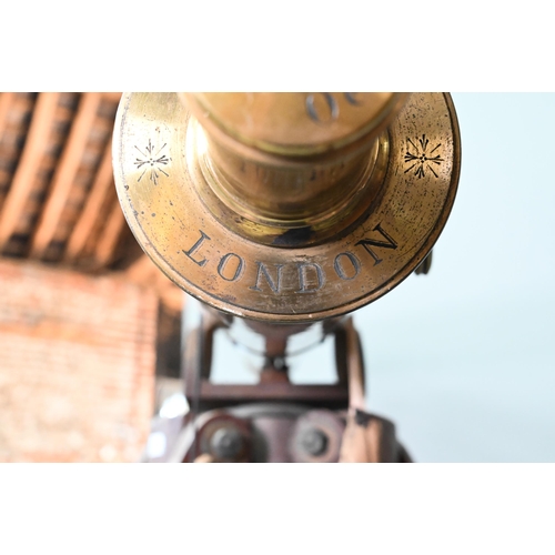 1234 - Dolland, London, a late 19th century brass tube telescope, raised on a folding wooden tripod stand -... 