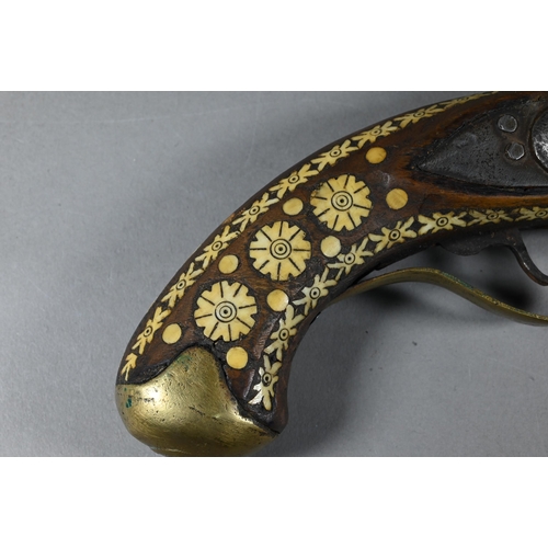 1068 - An Indo-Persian flintlock pistol with 25 cm barrel, the walnut fullstock richly inlaid with bone and... 