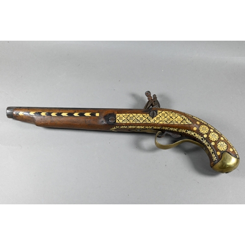 1068 - An Indo-Persian flintlock pistol with 25 cm barrel, the walnut fullstock richly inlaid with bone and... 