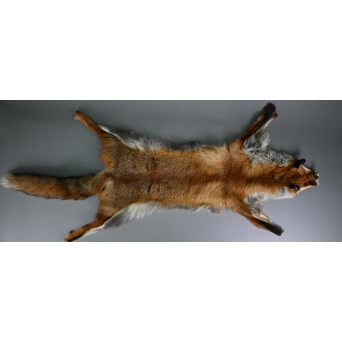 1144 - A deer-hide rug, 145 x 106 cm to/w a fox-fur rug with head and tail (2)