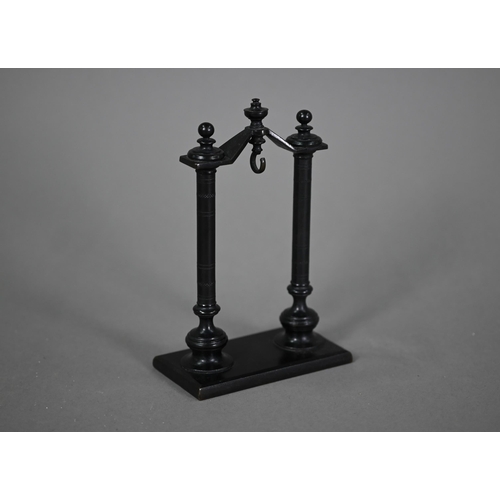 1165 - A brown-patinated bronze watch-stand, with turned pillar supports, 16.5 cm high