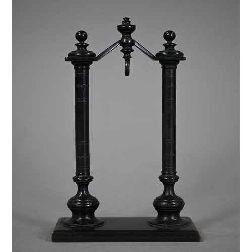 1165 - A brown-patinated bronze watch-stand, with turned pillar supports, 16.5 cm high