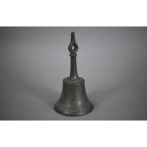 1167 - An antique bronze hand-bell with stylised floral-bud finial, 27 cm high