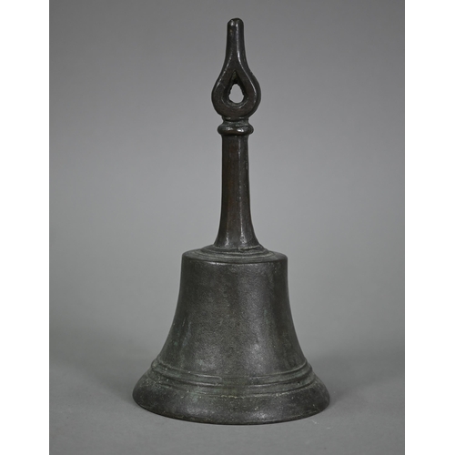 1167 - An antique bronze hand-bell with stylised floral-bud finial, 27 cm high