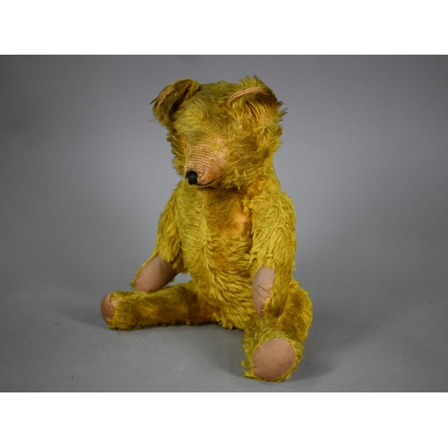 1192 - A vintage green/gold mohair teddy bear with stitched nose, swivel head and limbs, hump back and stit... 