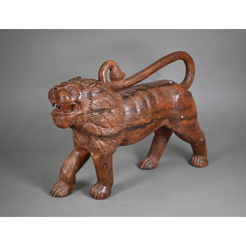 1229 - A mid-century hand carved weathered Asiatic lion, 50 cm long, 14 cm wide, 36 cm high