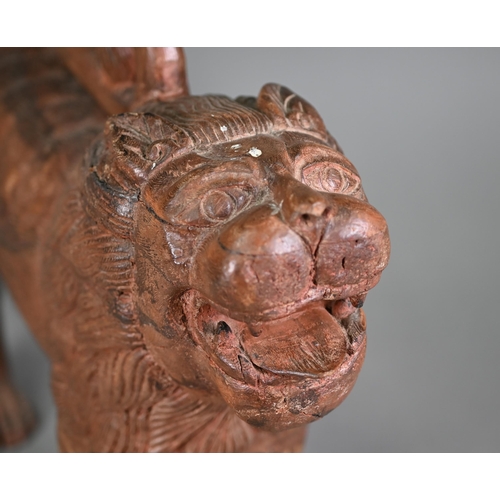 1229 - A mid-century hand carved weathered Asiatic lion, 50 cm long, 14 cm wide, 36 cm high