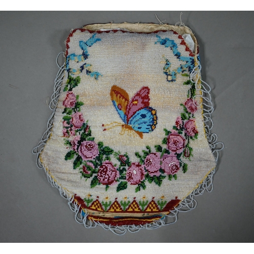 1120 - A 19th century glass beadwork pouch decorated with a basket of flowers to one side, and a butterfly ... 