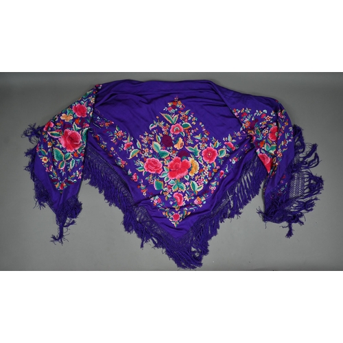 1124 - A circa 1930s Chinese silk 'piano' shawl, the purple ground profusely decorated with flowers in colo... 