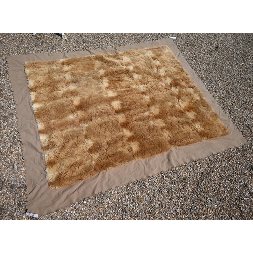 1147 - A fur travelling rug with felt border, 210 x 164 cm overall