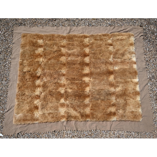 1147 - A fur travelling rug with felt border, 210 x 164 cm overall