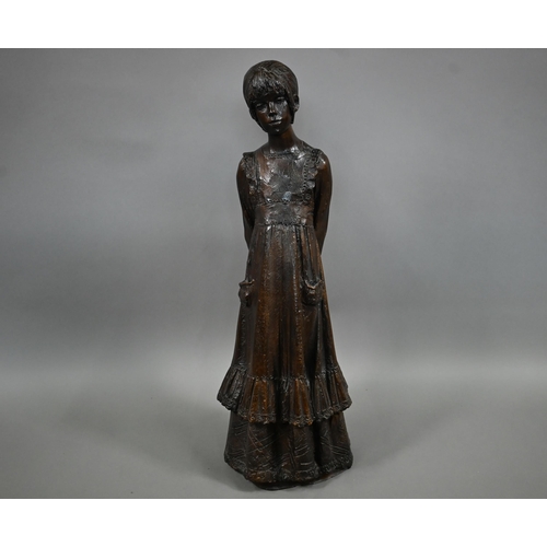 1210 - A bronzed pottery sculpture of a young woman, standing, in a long dress, 77 cm h