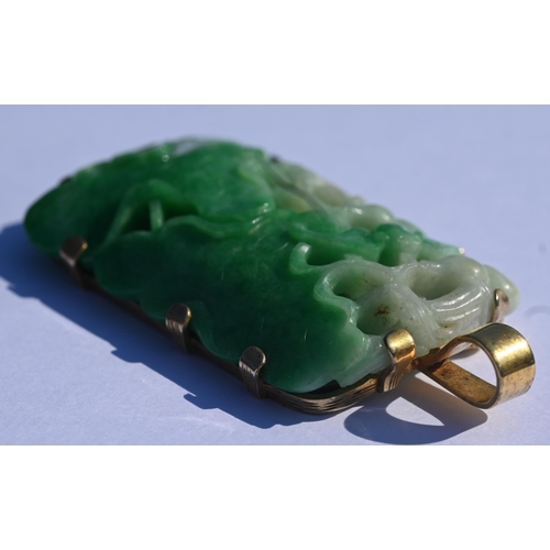 225 - A Chinese jade pendant, the pierced rectangular plaque of moss on snow jade carved with stylised lot... 