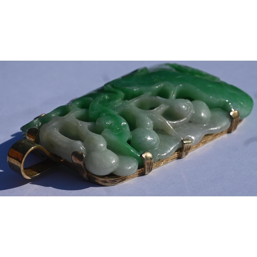 225 - A Chinese jade pendant, the pierced rectangular plaque of moss on snow jade carved with stylised lot... 