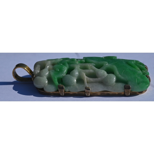 225 - A Chinese jade pendant, the pierced rectangular plaque of moss on snow jade carved with stylised lot... 