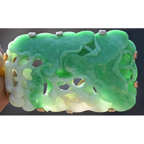 225 - A Chinese jade pendant, the pierced rectangular plaque of moss on snow jade carved with stylised lot... 