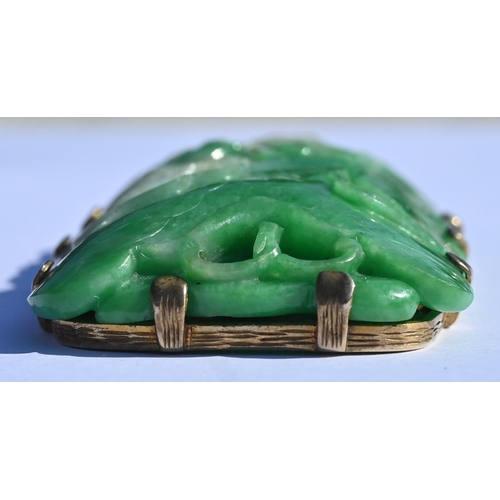 225 - A Chinese jade pendant, the pierced rectangular plaque of moss on snow jade carved with stylised lot... 