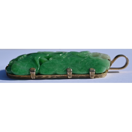 225 - A Chinese jade pendant, the pierced rectangular plaque of moss on snow jade carved with stylised lot... 