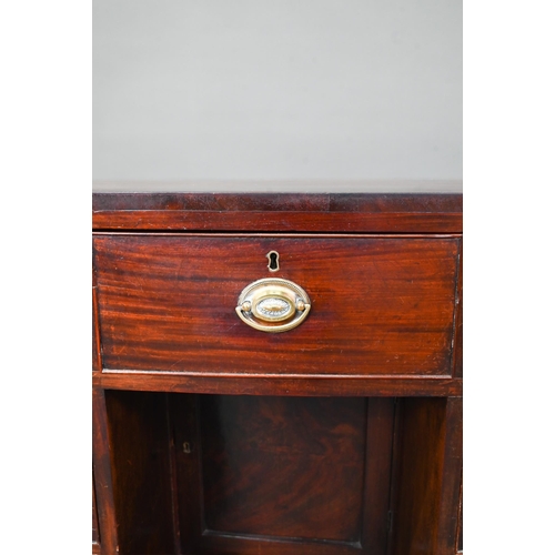 410 - # A Victorian mahogany bowfront kneehole desk, with six drawers and recessed cupboard, raised on spl... 