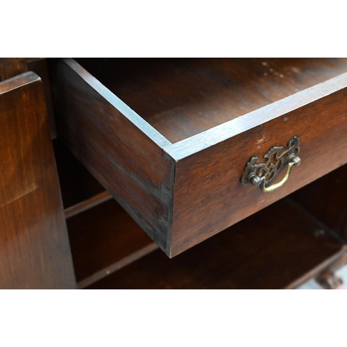 411 - An Oriental style walnut two door cocktail/side cabinet with engraved brass mounts, shell carved bal... 