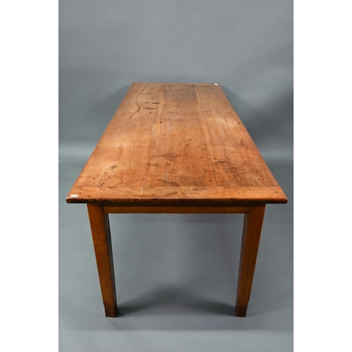 541 - An antique French cherry wood farmhouse table, the plank top with cleated ends and later draw leaf e... 