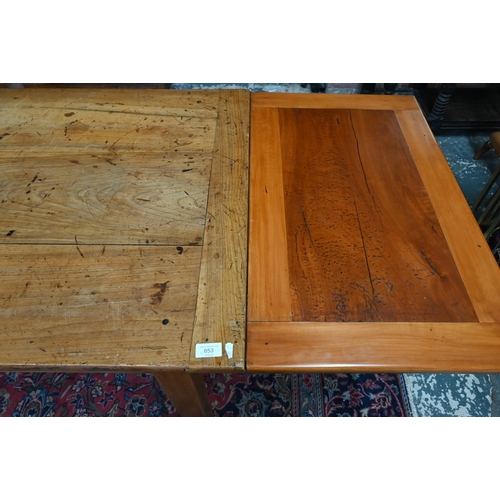 541 - An antique French cherry wood farmhouse table, the plank top with cleated ends and later draw leaf e... 