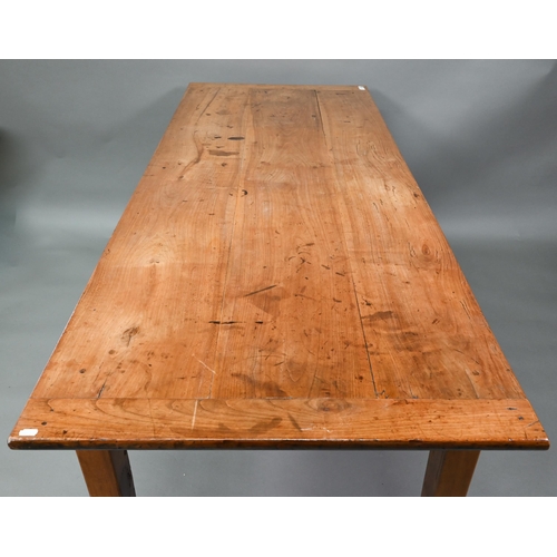 541 - An antique French cherry wood farmhouse table, the plank top with cleated ends and later draw leaf e... 