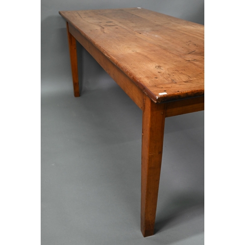 541 - An antique French cherry wood farmhouse table, the plank top with cleated ends and later draw leaf e... 