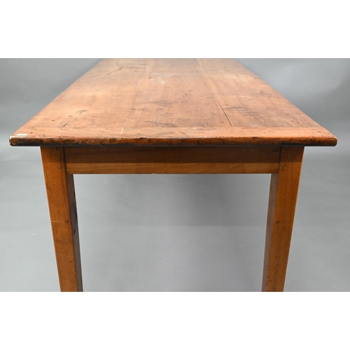 541 - An antique French cherry wood farmhouse table, the plank top with cleated ends and later draw leaf e... 