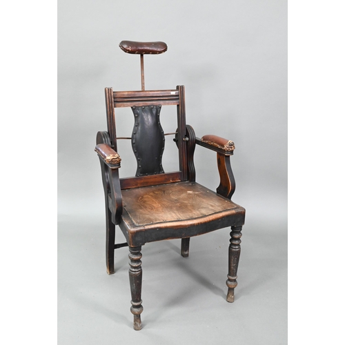 An early 20th century barber's chair, bears makers plate for J W Clarke, Borough, London