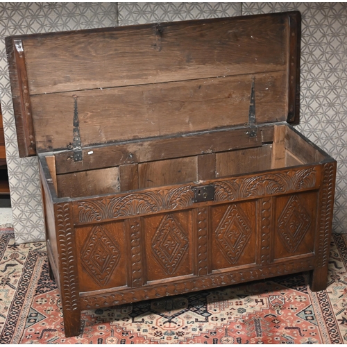 471 - An early 18th century carved oak coffer, 145 cm x 57 cm x 71 cm h