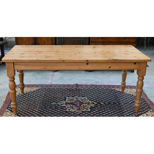 552 - Stained pine kitchen dining table on turned supports, 182 cm wide x 90 cm deep x 78 cm high