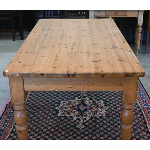 552 - Stained pine kitchen dining table on turned supports, 182 cm wide x 90 cm deep x 78 cm high