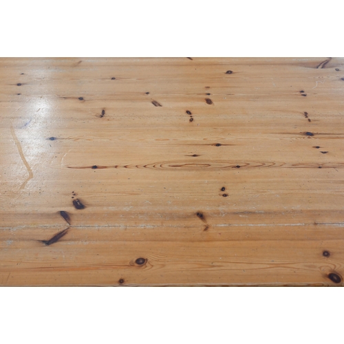 552 - Stained pine kitchen dining table on turned supports, 182 cm wide x 90 cm deep x 78 cm high