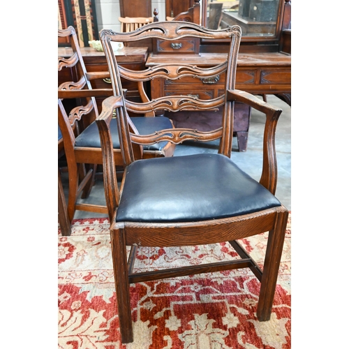 599 - A set of four elm wavy ladderback dining carver chairs with dark blue leather pad seats