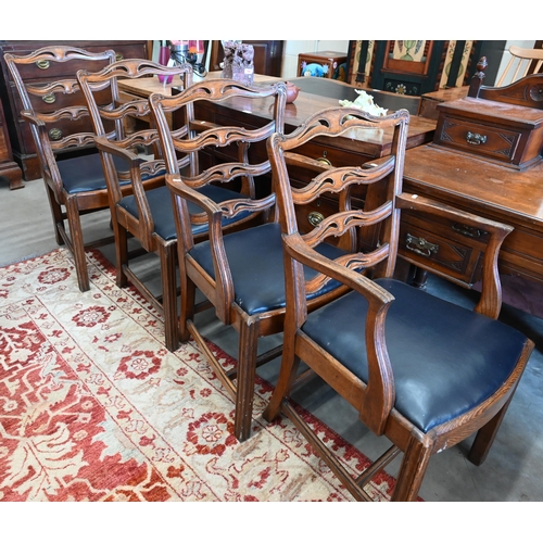 599 - A set of four elm wavy ladderback dining carver chairs with dark blue leather pad seats