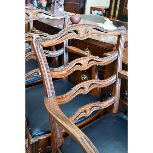 599 - A set of four elm wavy ladderback dining carver chairs with dark blue leather pad seats