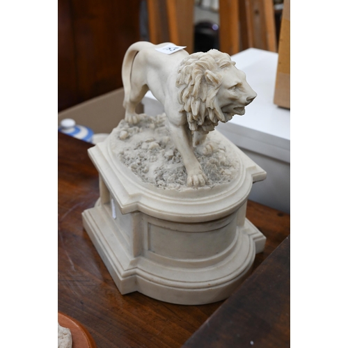 153 - An ornamental resin box surmounted by a lion to/w a couple on a swing, a table lamp with putti and a... 