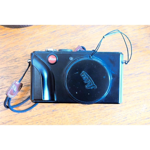 180 - A Leica D-Lux 4 digital pocket camera with leather case and battery-charger with spare battery