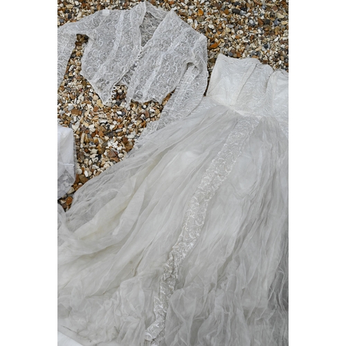 245 - A vintage lace, gauze and silk wedding dress with petticoat, full pleated underskirt, buttoned jacke... 