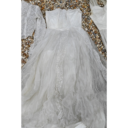 245 - A vintage lace, gauze and silk wedding dress with petticoat, full pleated underskirt, buttoned jacke... 